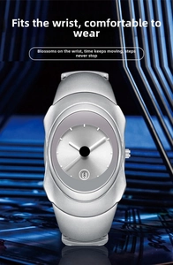 Macro view of silver Y2K quartz watch showing the grey dial and date window detail