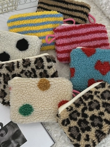 Plush heart and polka dot cosmetics organizer bag set with various vibrant patterns