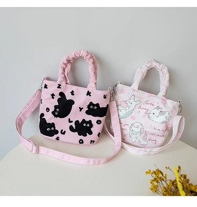 Detail of cute canvas bucket bags with pleated handles and adjustable shoulder straps