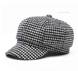 Detailed texture of white houndstooth newsboy hat in thick tweed for winter fashion