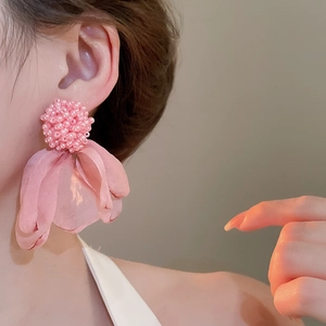 Detailed close-up of pink cluster flower fabric earrings showing beadwork and soft tulle