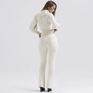 Women's chic beige knitted two-piece set featuring long sleeve top and flared trousers