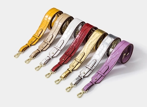 Detailed view of adjustable faux crocodile skin wide shoulder straps in seven vibrant colors