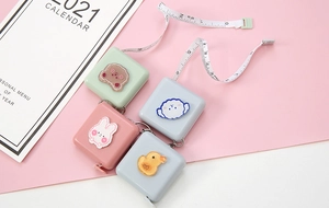 Detail of macaron-colored mini retractable tape measures with cute 3D cartoon animals