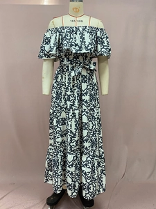 Detail of off-shoulder floral maxi dress featuring tiered ruffles and baroque patterns