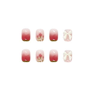Pink gradient press-on nails with 3D white bows and tulip floral nail art designs