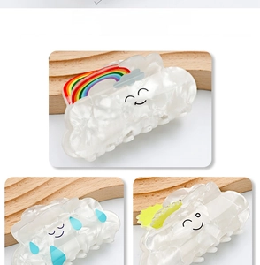 Detailed view of acetic acid rainbow cloud hair claws with sweet cartoon patterns