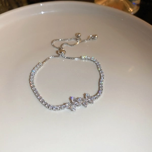 Detailed close-up of a silver zircon butterfly bracelet with an adjustable drawstring buckle