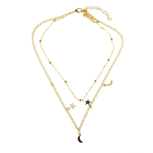 Macro detail of gold layered star and moon charm necklaces with beaded chain finish