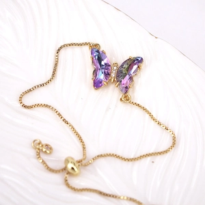 Gold adjustable box chain bracelet featuring a purple crystal butterfly pendant charm