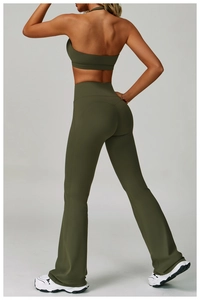 Rear view of olive green backless yoga set with halter bra and flare leggings