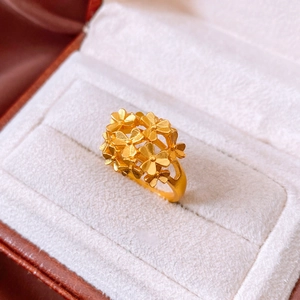 Detailed macro view of 24k gold-plated floral ring on a velvet jewelry box