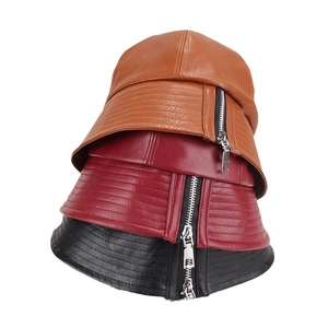 Detailed close-up of colorful PU leather newsboy hats with stylish metal zipper trim