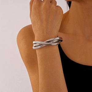 Close-up of a silver multi-layer snake chain wrapped bracelet with textured metal details
