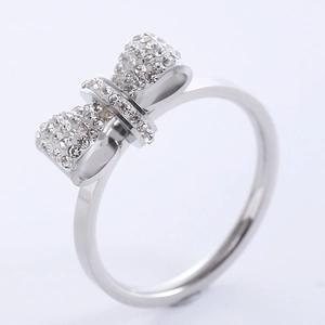 Elegant silver bow ring for women with sparkling white crystals on a white background