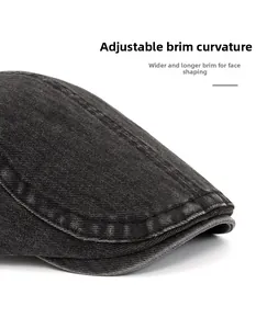 Detail of a flexible foldable brim on a dark gray washed denim vintage flat cap