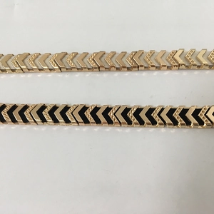 Detail of gold and black arrow link metal elastic belts for women fashion dresses