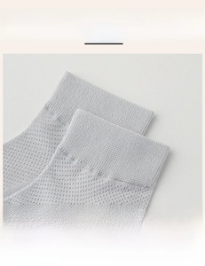 Detailed macro view of light gray mesh socks featuring a high-elastic ribbed cuff