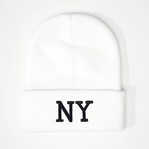 Close-up of black NY letter embroidery on a white ribbed knit beanie hat