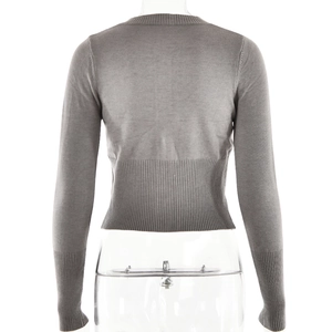 Detail of grey knitted cardigan with ribbed hem and elongated cuffs on a model