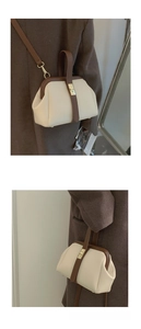 Detail of vintage doctor-style bag with gold twist lock and adjustable shoulder strap