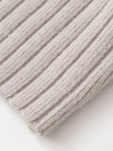 Close-up of light gray ribbed knit fabric texture showing soft wool fiber details