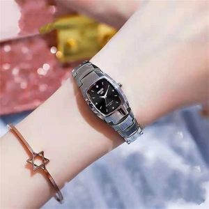 Close-up of rectangular black dial watch with silver steel band and star bracelet