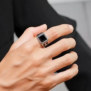 Men's silver open ring featuring a square black stone with side floral relief carving