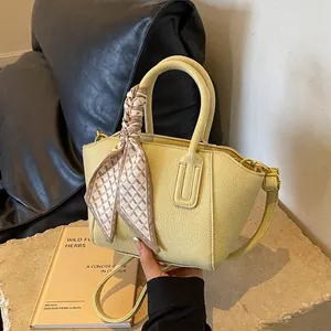 Chic yellow lychee pattern leather bucket bag with silk scarf handle and crossbody strap