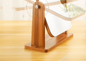 Detail view of wooden vanity mirror showing its 360-degree smooth rotation feature