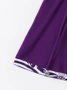 Detailed view of purple tankini hem with abstract white and purple floral patterns