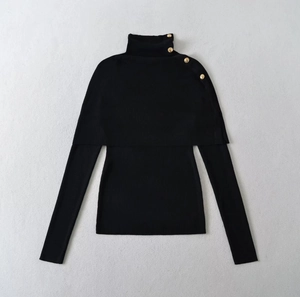Detailed view of black ribbed knit sweater with decorative gold buttons on the collar