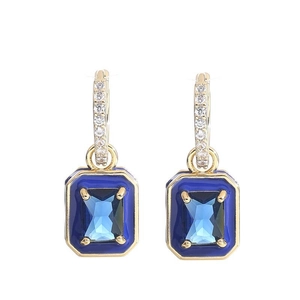 Detail showing 18K gold hoop earrings with rectangle blue crystal and enamel accents
