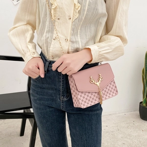 Pink quilted crossbody bag with gold deer head tassel and metal chain strap detail