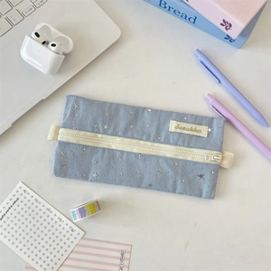 Close-up of star pattern stationery bag with sturdy zipper and brand woven label