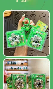 Close-up of panda fishing game keychain with mini panda figures and green bell hook