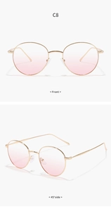 Detail of pink gradient lenses and golden engraved metal frame on heart sunglasses