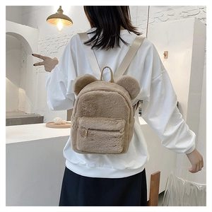 Detailed back view of a khaki plush backpack with cute bear ears on a model
