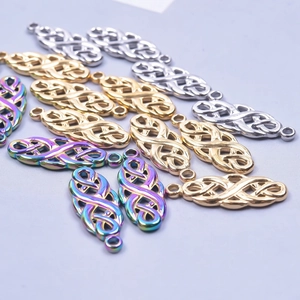 Detailed macro view of gold, silver, and aurora celtic witch knot pendants for DIY jewelry