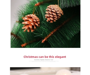 Close-up of a rustic brown pine cone ornament with snow effect on a green Christmas tree