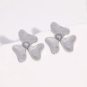 Macro detail of silver titanium clover earrings with streamlined petal texture