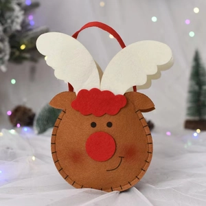 Close-up of reindeer felt Christmas gift bag with festive bokeh lights background