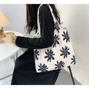 Detailed view of the large capacity canvas tote bag with abstract floral print
