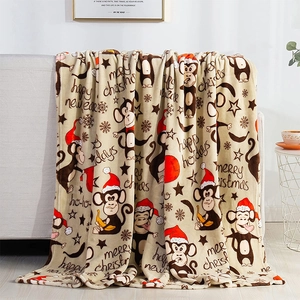 Detail of Christmas flannel blanket with cartoon monkeys draped over a sofa