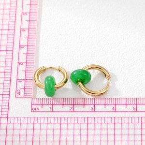 Vintage stainless steel gold hoop earrings with natural green stone beads on white background