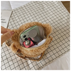 Top view of plush bear crossbody bag interior showing phone and lipstick storage