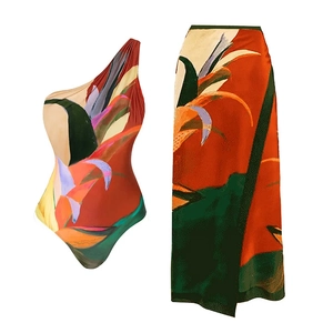Detailed view of one-shoulder tropical floral swimsuit set with matching wrap skirt