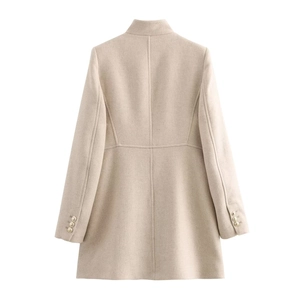 Back view of oat-colored long coat featuring standing collar and gold cuff buttons