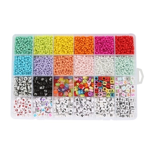 Macro view of a 24-grid organizer box filled with colorful DIY acrylic beads and letters