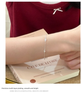 Close-up of S925 silver flower bracelet with exquisite small petals on a model's wrist